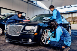 Car cleaning by three people at the best car wash service with Magic Wash