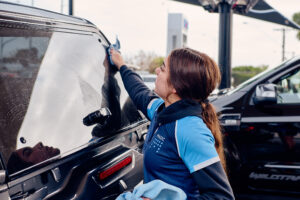 magic hand car wash attendant washing a customer car in Richmond store