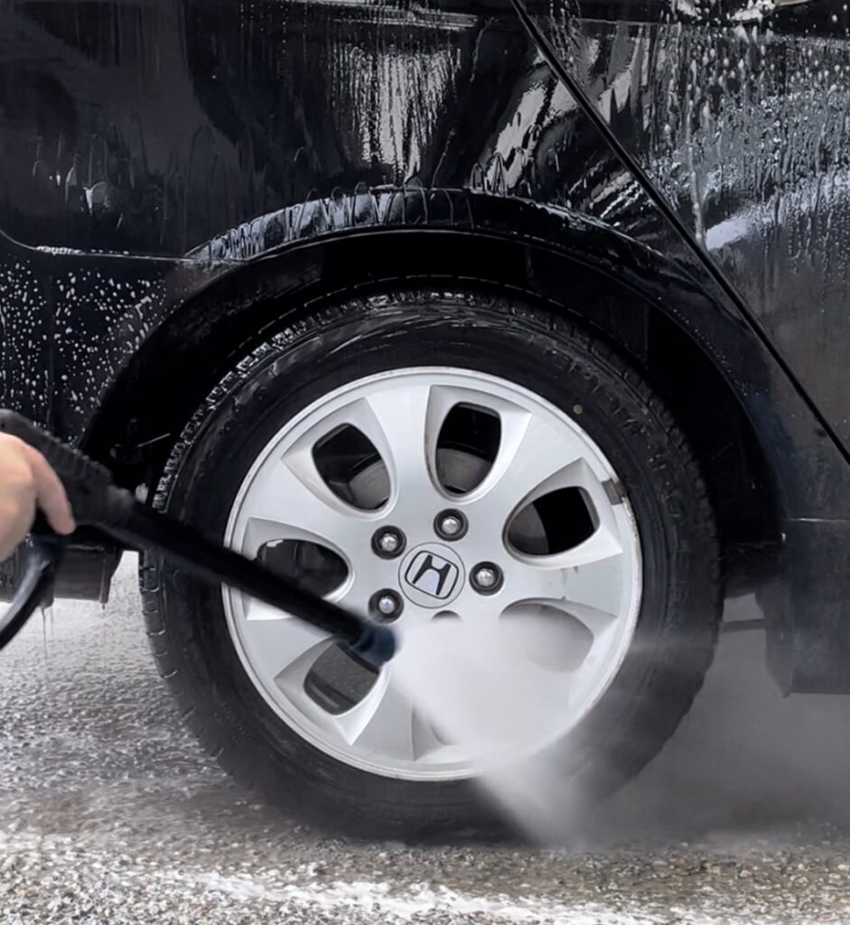 a car wheel being cleaned in at Magic Hand Carwash store