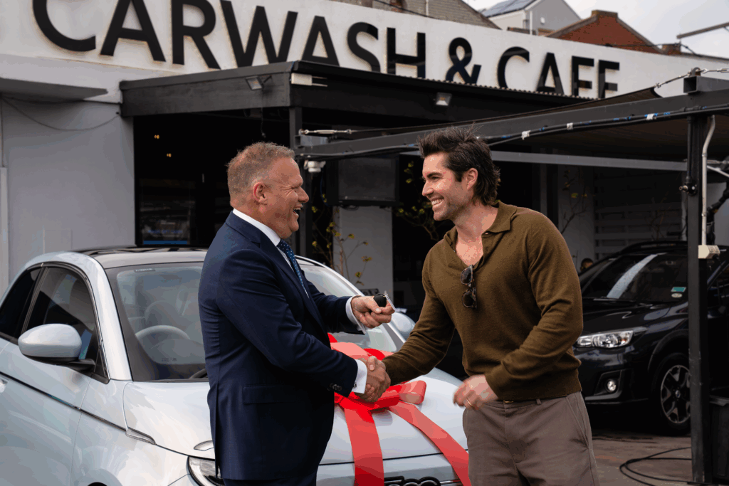 Zac Handing over the Fiat 500e to the lucky winner in Magic Carwash at Richmond Store