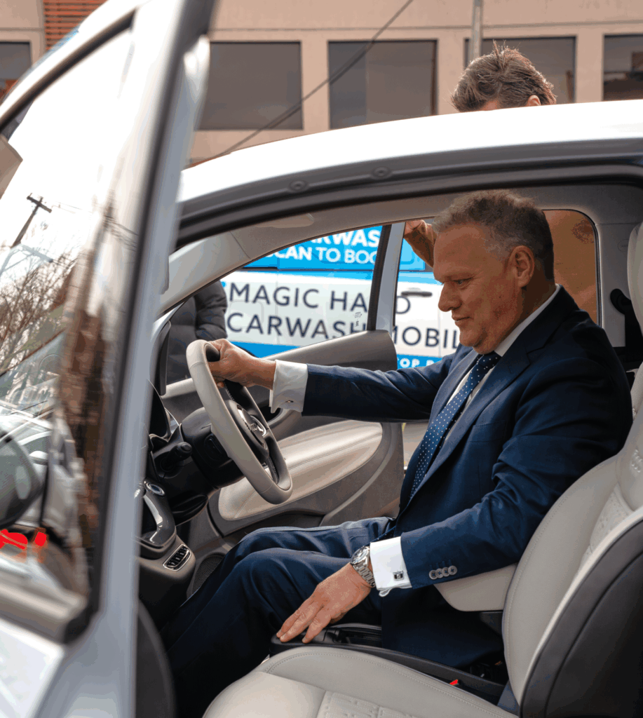 Winner having a look at the Fiat 500e giveaway car from Magic Hand Carwash
