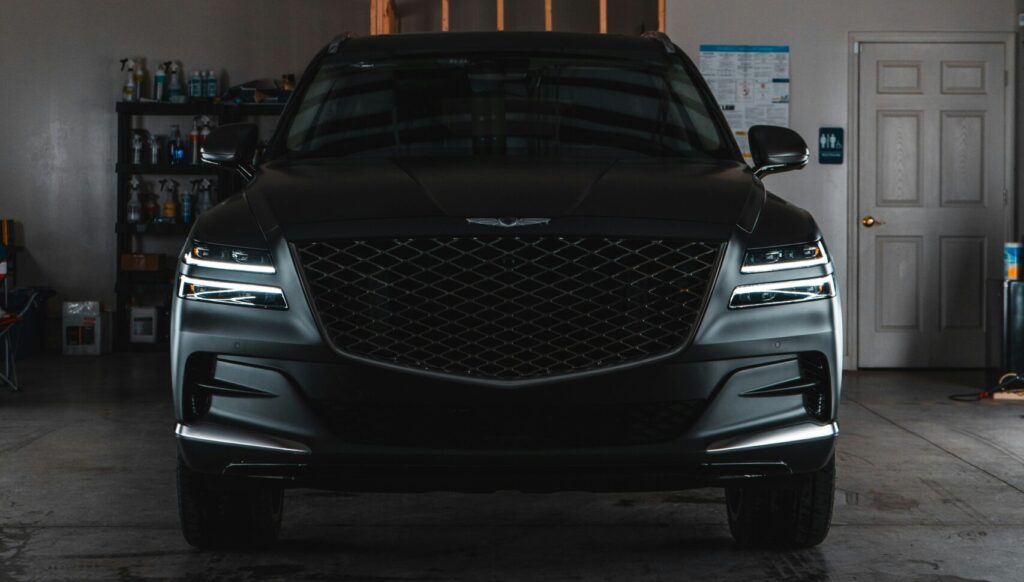 Car is getting clay bar treatment in Magic Car Wash